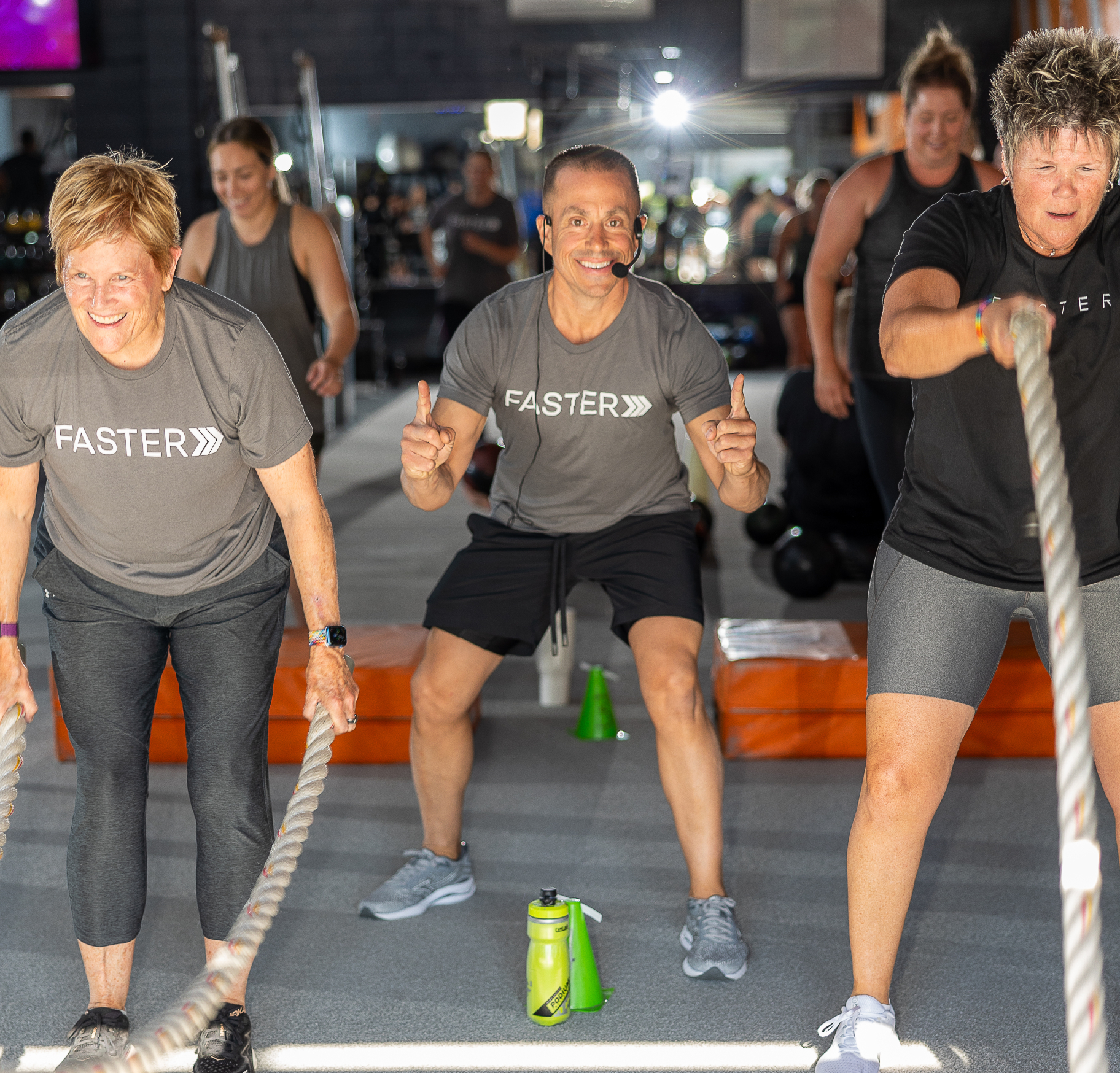 FASTER Personal Training session with coach and clients doing battle ropes